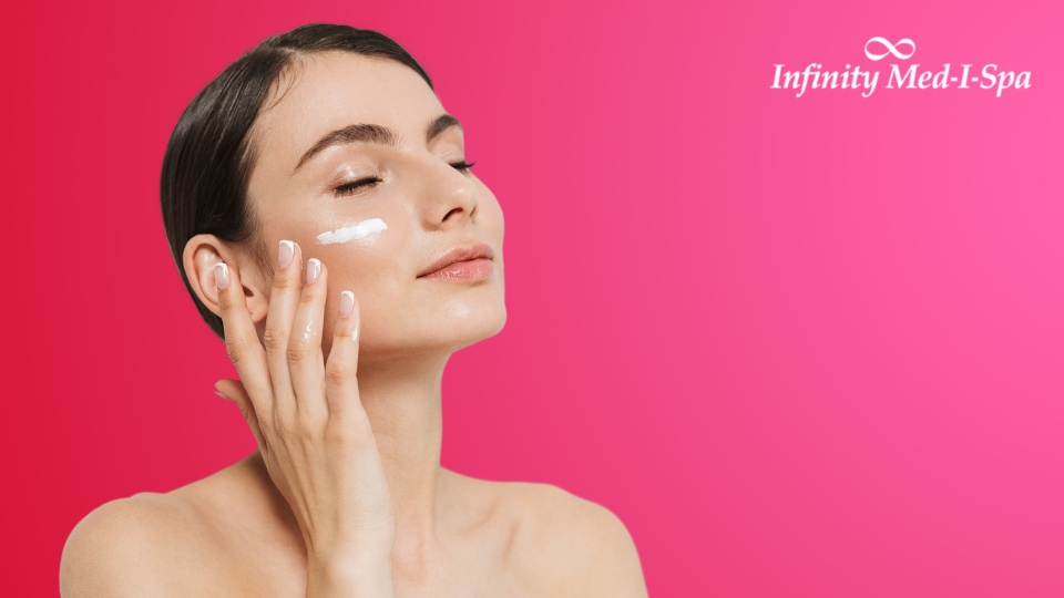 beautiful woman with eyes closed applying face cream